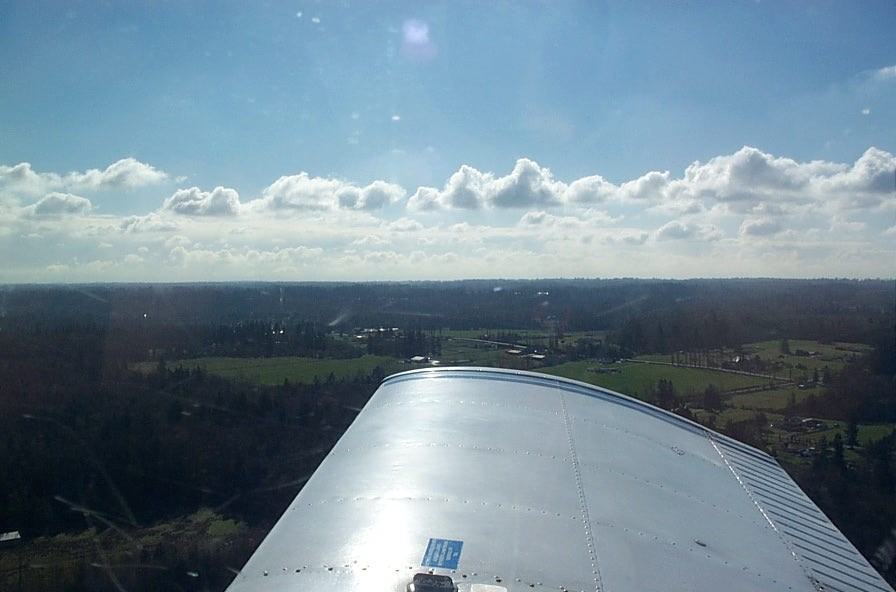 Piper Cherokee GNIC's right wing over the Glen Valley Practice Area. Langley Flying School.